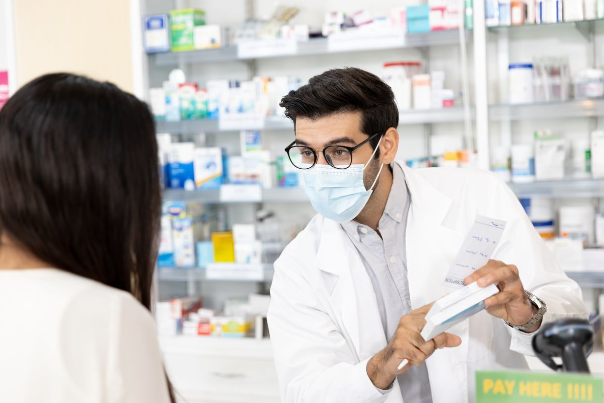 Pharmacist explaining medicine to a patient